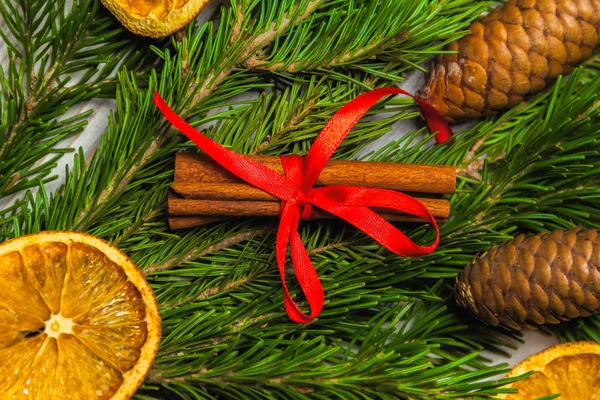 Christmas and New Year composition. Pine branches, cinnamon sticks, dried slices of orange and walnuts. Christmas and New Year concept. Flat lay Stock Picture