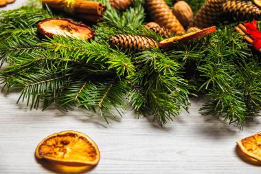 Yeni Yıl tatil süslemeleri. Fındık, tarçın ve kurutulmuş meyve suni kar ile toz ile köknar dalları El yapımı Noel çelenk