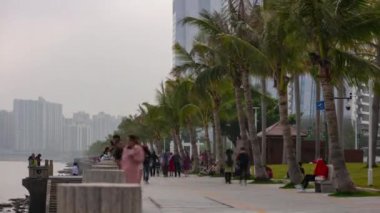 People walking on Macau Taipa island seacoast. 4k timelapse footage china