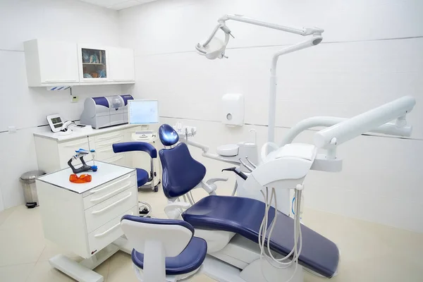 New white interior of a dental office, dental chair, wet milling and grinding machine, intra oral scanner. Dentists office. Dental laboratory