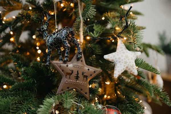 Noel ağacındaki Noel süsleri. Oyuncak yıldızlar ve geyik. 