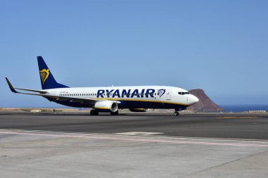 Tenerife, Kanarya Adaları, İspanya - 28 Temmuz 2025: Arka planda Atlantik Okyanusu olan bir Ryanair uçağı iniş yaptı.