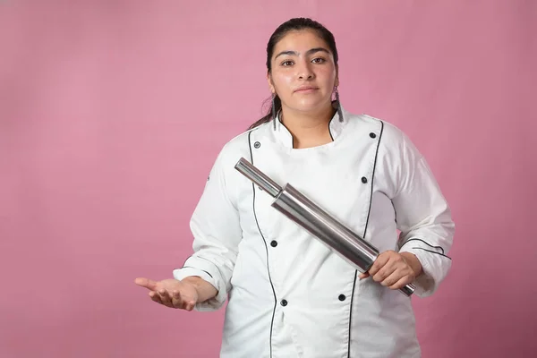Chef woman with challenge and authority gesture with her stainless steel roller- Latin chef