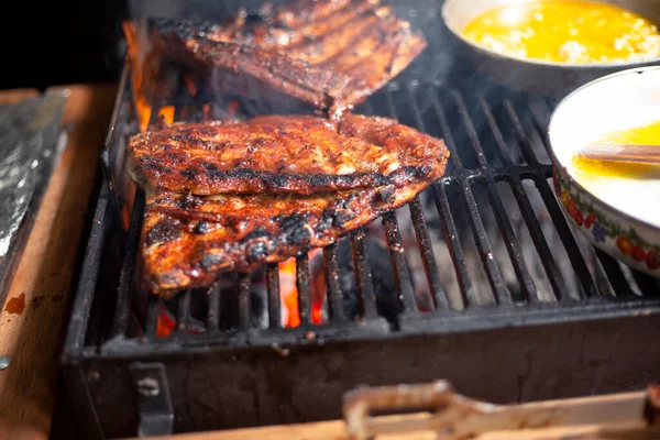 Grilled pork ribs, delicious grilled ribs, home barbecue - cooking grilled meat