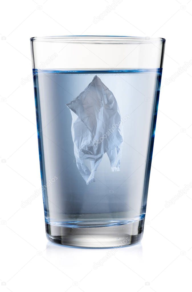 Pollution Concept. Plastic Bag Floating Inside a Drinking Glass