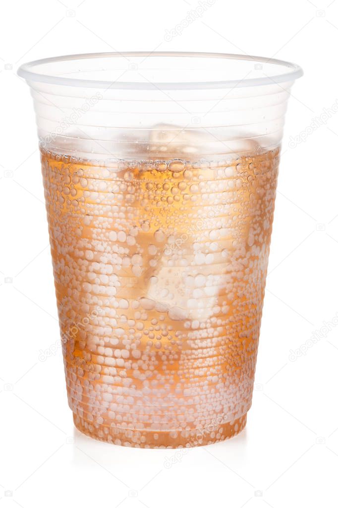 Guarana carbonated drink with ice in a plastic cup isolated on w