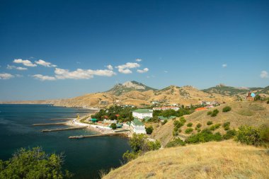 Kurortnoe (An Urban-Type Settlement) In Feodosia, Crimea. Beautiful Scenic View From Mountain On Sunny Day In Summer. clipart