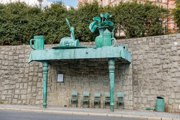 Devler Bayramı otobüsü bitkilere karşı duvar kenarında duruyor. Sanatçı: David Cerny. Liberec, Kuzey Bohemya, Çek Cumhuriyeti, 16 Ağustos 2020.