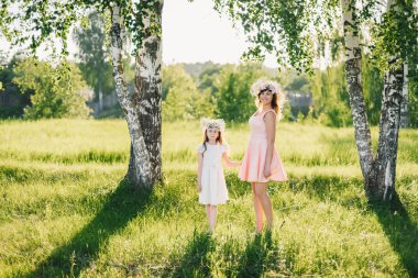 Anne ve kızı açık havada dinlenme güneşli bir yaz elbiseler