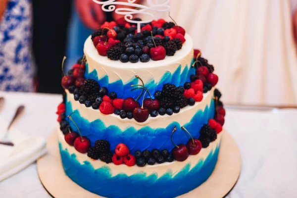 Wedding cake in white blue glaze with berries cherries, blueberries, blackberries, raspberries — Stock Photo, Image