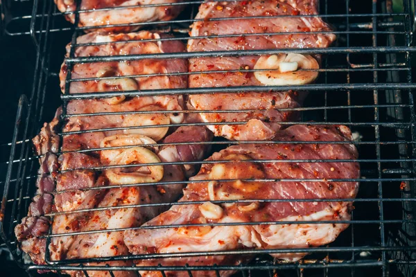 Pork meat with onions fried on the grill for barbecue — Stock Photo, Image