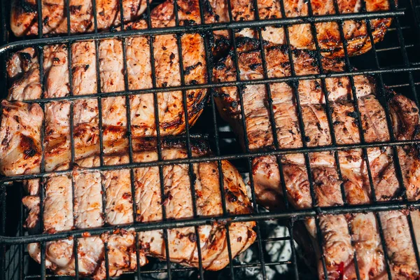 Pork meat is cooked on the grill on the coals — Stock Photo, Image