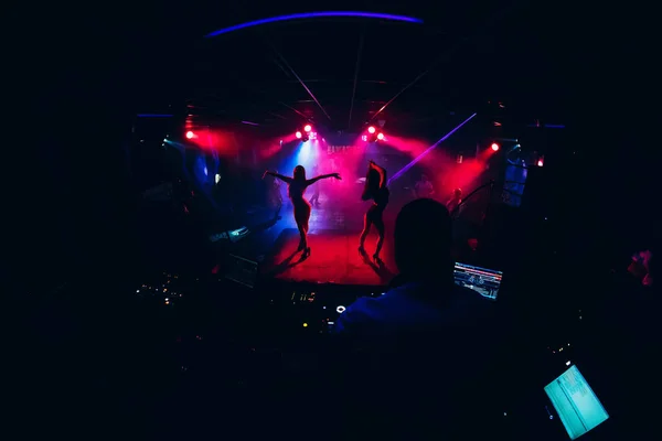 dancers dancing go-go on stage in a nightclub