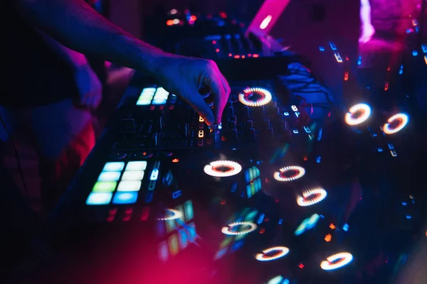 DJ plays on music mixer in a nightclub — Stock Photo, Image