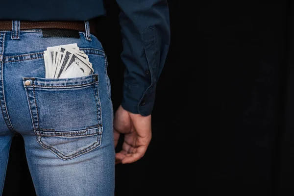 Dólares de dinero y un condón en el bolsillo trasero de jeans para hombre —  Fotos de Stock