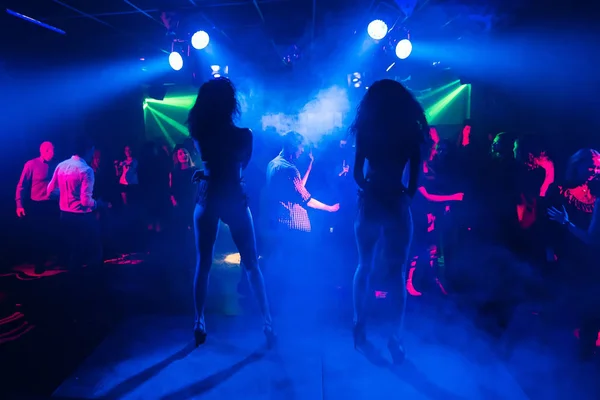 dancers dancing go-go on stage in a nightclub