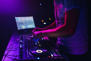 hands of a DJ in a booth playing on the mixer clipart