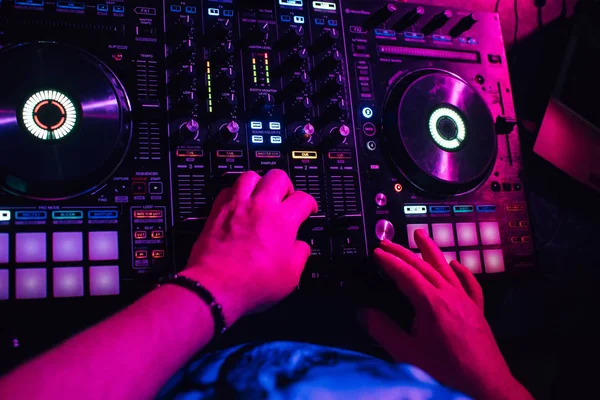 DJ in booth playing in nightclub on background of mixer — Stock Photo, Image