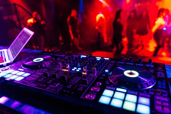 Professional DJ mixer controller for mixing music in a nightclub Stock Picture