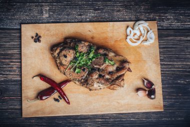 sarımsak, soğan, biber ile ahşap bir gemide domuz eti pişmiş