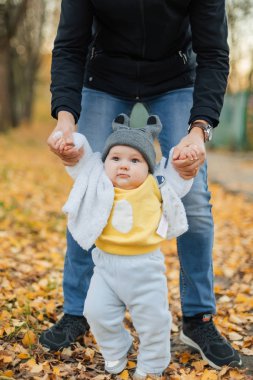 küçük bebek çocuk babamın ellerini tutarak ilk adımları atmaya öğrenir