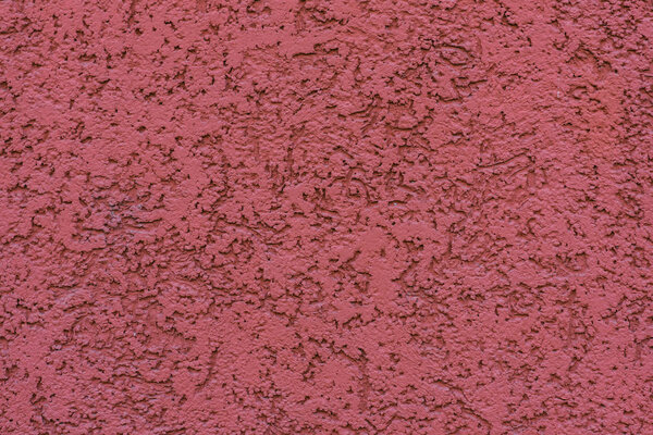 структура текстурированной штукатурки на красной стене
