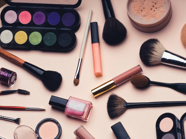 Women's cosmetics and makeup set on pink background. Top view