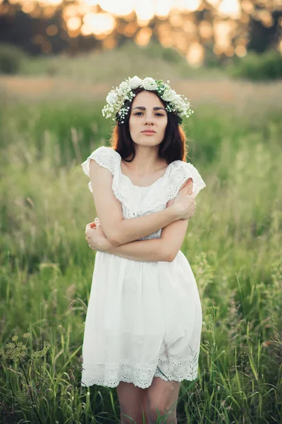 白いドレスと花の花輪の魅力的なブルネットの少女の肖像画 — ストック写真