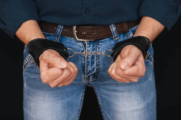 Male hands in leather handcuffs for bdsm sex — Stock Photo, Image