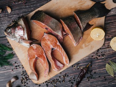 limon ve baharat ahşap masa üzerinde alabalık gemide dilimlenmiş. Taze kırmızı balık