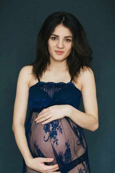Grossesse. enceinte jeune caucasien brunette fille dans un peignoir tenir ventre — Photo