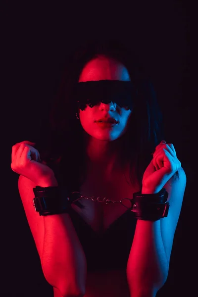 Sexy beautiful young girl in handcuffs and lace blindfold — Stock Photo, Image