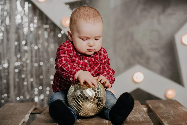 Boldog újszülött fiú ül a háttérben a karácsonyi dekoráció — Stock Fotó
