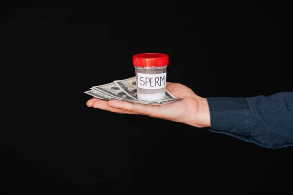 Bank of sperm and money in the hand of a man — Stock Photo, Image