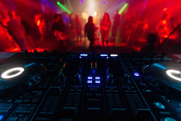 Professional DJ mixer controller for mixing music in a nightclub Stock Picture