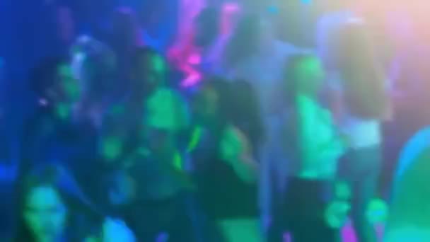 Размытые силуэты группы танцующих людей на танцполе в ночном клубе — стоковое видео