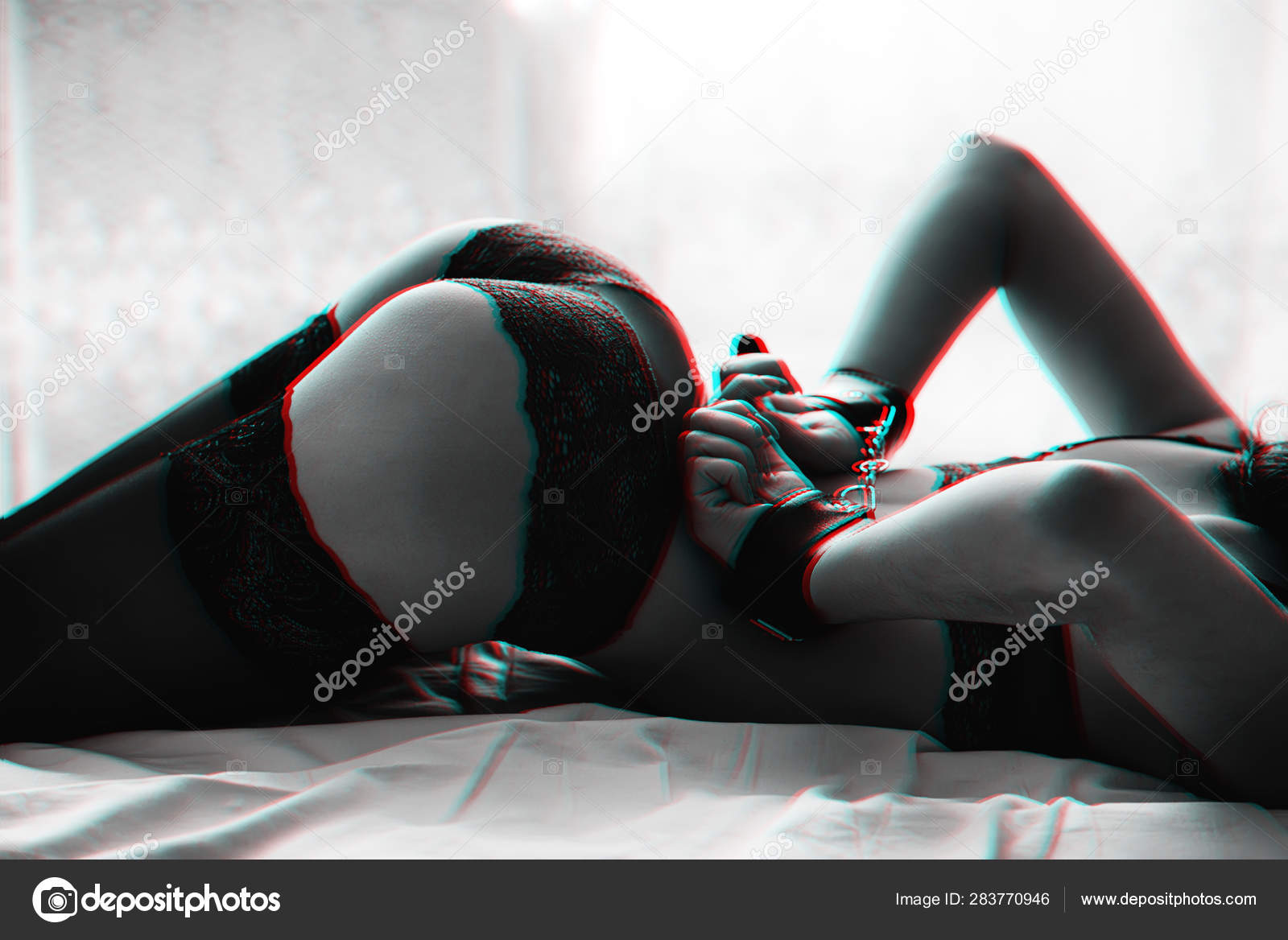 Big ass slender young woman in lingerie with stockings and handcuffed hands for BDSM sex Stock Photo by ©alexkoral 283770946 picture image
