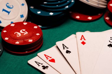 yeşil masada oyun yongaları arka planda poker asbir kare ile kartlar