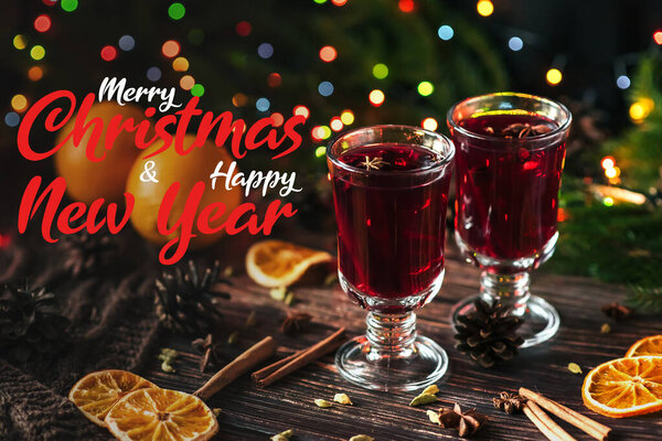 winter hot drink mulled wine in glasses on the table with the inscription Merry Christmas and Happy New Year