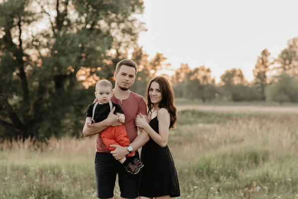 Happy Caucasian parents with son in summer field — Stock Photo, Image