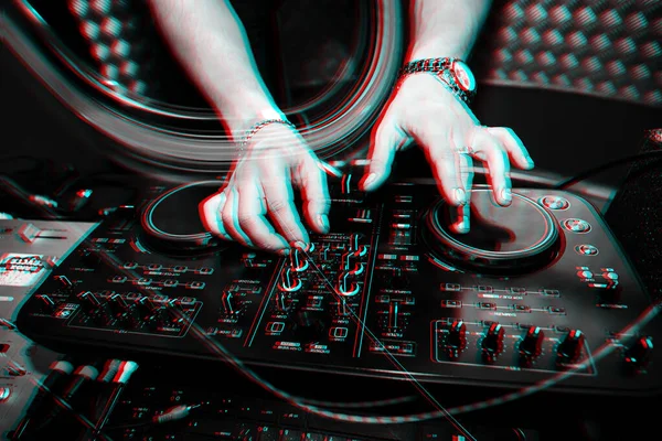 Music remote for information and mixing music in nightclub with DJ hands close seup — стоковое фото