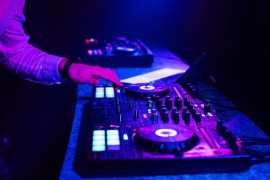 DJ hands mix music on a mixing Board in a nightclub clipart