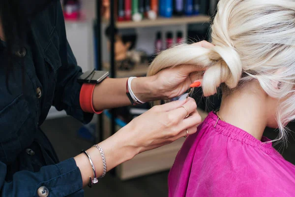 Bollo de peinado en la cabeza de la chica rubia. Preparación para el día de la boda en el salón de belleza — Foto de Stock