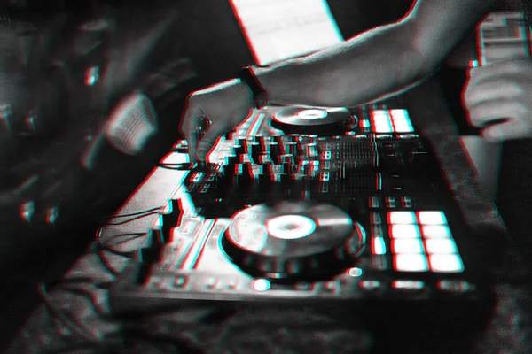 Руки DJ играет электронную современную музыку на микшерной консоли на концерте в ночном клубе — стоковое фото