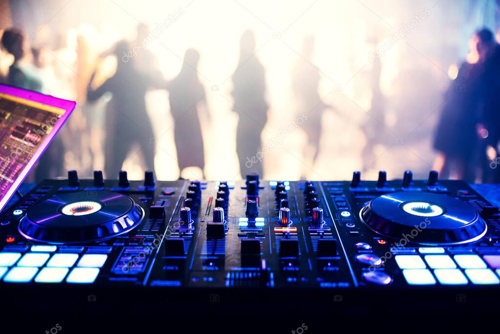 music controller DJ mixer in a nightclub at a party