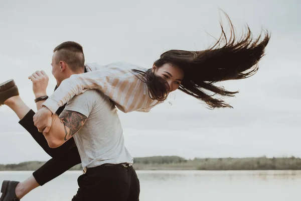 Glada par flicka och kille som har kul på stranden — Stockfoto