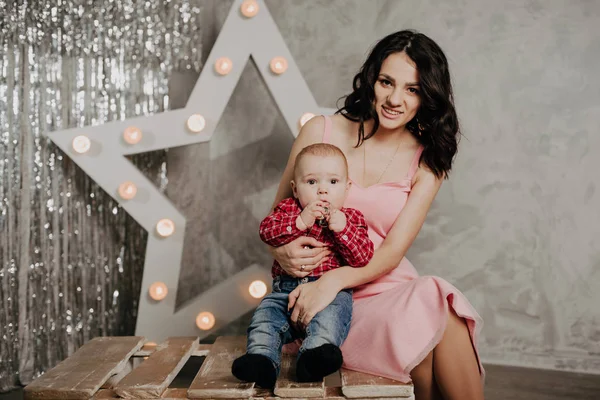 Mom With Newborn Baby Boy Son In Her Arms On The Background Of Christmas Decor Childhood Woman Stock Photo Mom With Newborn Baby Boy Son In Her Arms On The Background Of Christmas Decor Childhood Woman Stock Photo