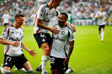 Ermal Krasniqi, Damian Szymanski and Juergen Elitim seen celebrating after scoring goal during PKO BP Ekstraklasa 25 26 game between teams of Legia Warszawa and Radomiak Radom at Wojska Polskiego Stadium (Maciej Rogowski/Ball Raw Images)