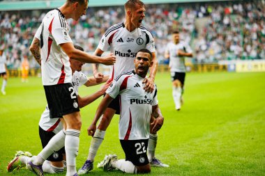 Ermal Krasniqi, Damian Szymanski and Juergen Elitim seen celebrating after scoring goal during PKO BP Ekstraklasa 25 26 game between teams of Legia Warszawa and Radomiak Radom at Wojska Polskiego Stadium (Maciej Rogowski/Ball Raw Images)