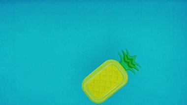 Hava. ananas, plaj yatak su havuzu üstten görünüm kristal temiz su yüzey, Güneş Parlatıcı parlak su havuzu döngü ağır çekim arka plan içinde yüzen